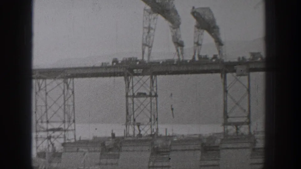 1938 Washington 8mm still showing crane-like gantries and vertical supports at an industrial extraction site.