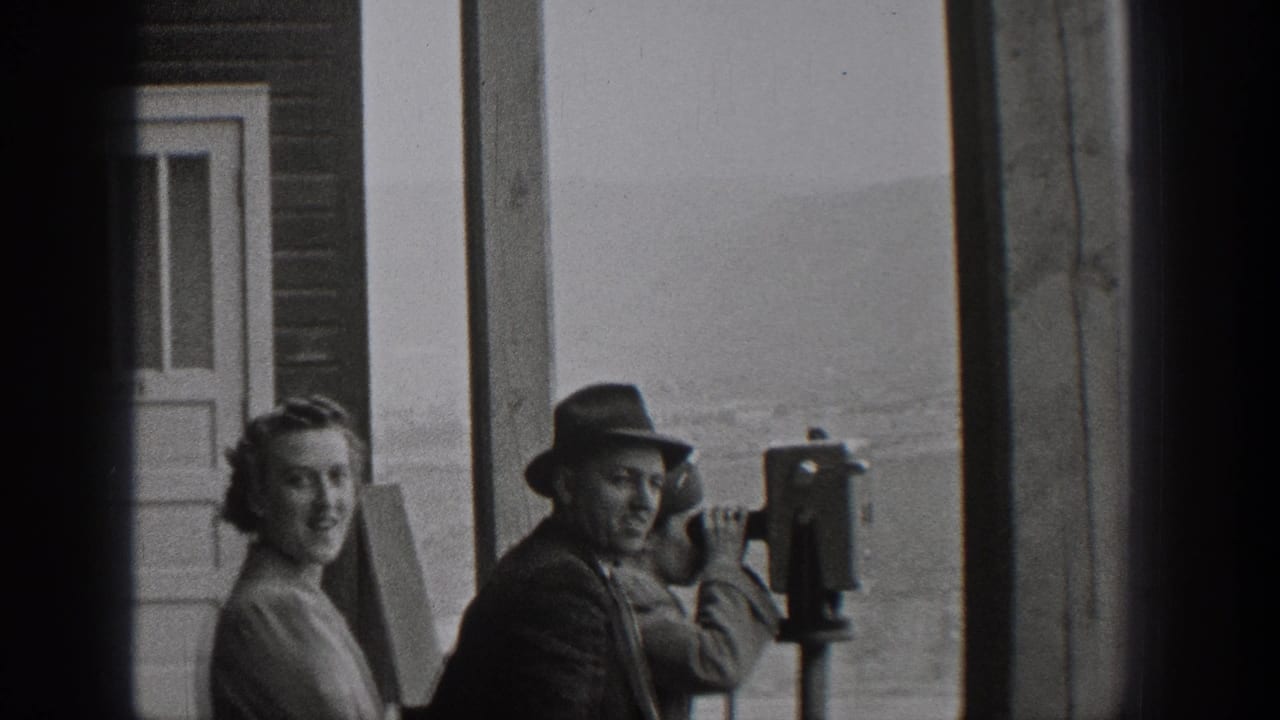 1938 Washington home-movie frame showing tourists beside coin-operated viewers at an outdoor overlook.