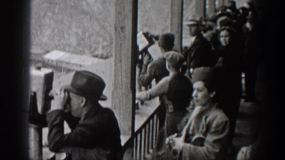 1938 Washington overlook scene with visitors in hats and coats near a railing and viewing scope.