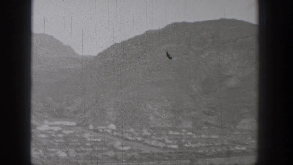 1938 Washington 8mm frame showing a hazy mountain foothill landscape with a small valley village below.