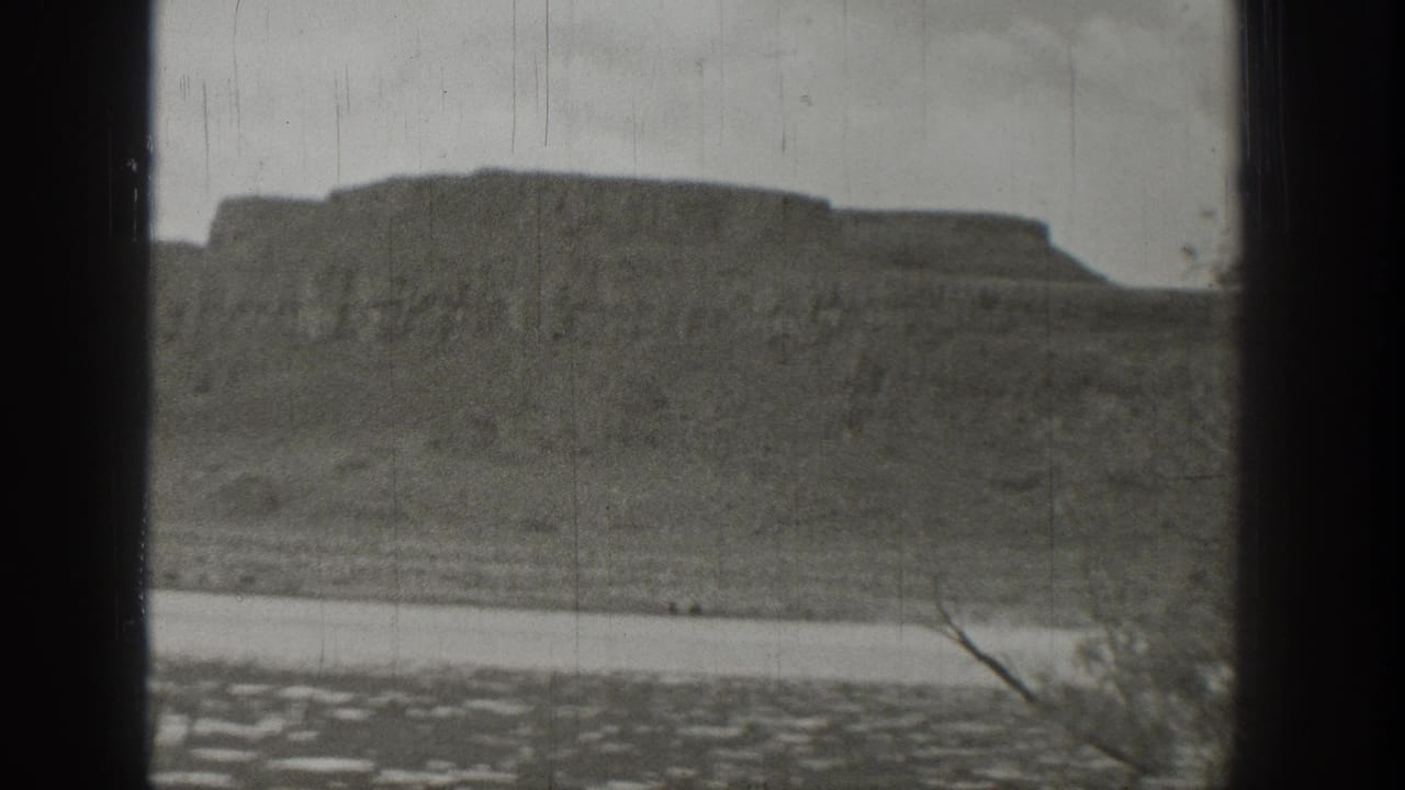 Rugged Washington lakeside cliffs fill the frame as rippled water crosses the foreground in soft 8mm footage.