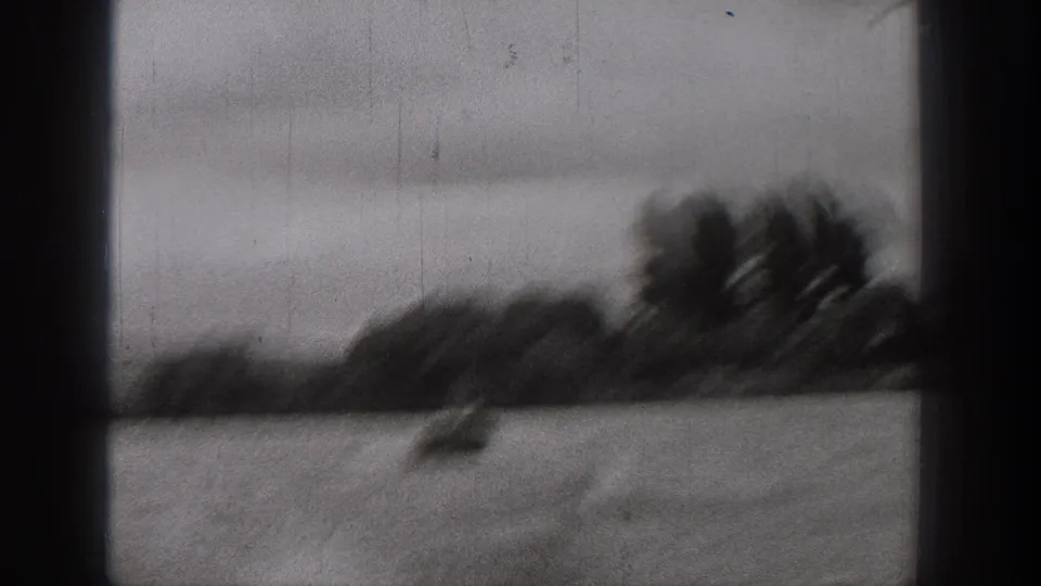 Motion-blurred 1938 Washington river frame with a small boat on choppy water and a dark wooded bank in the distance.