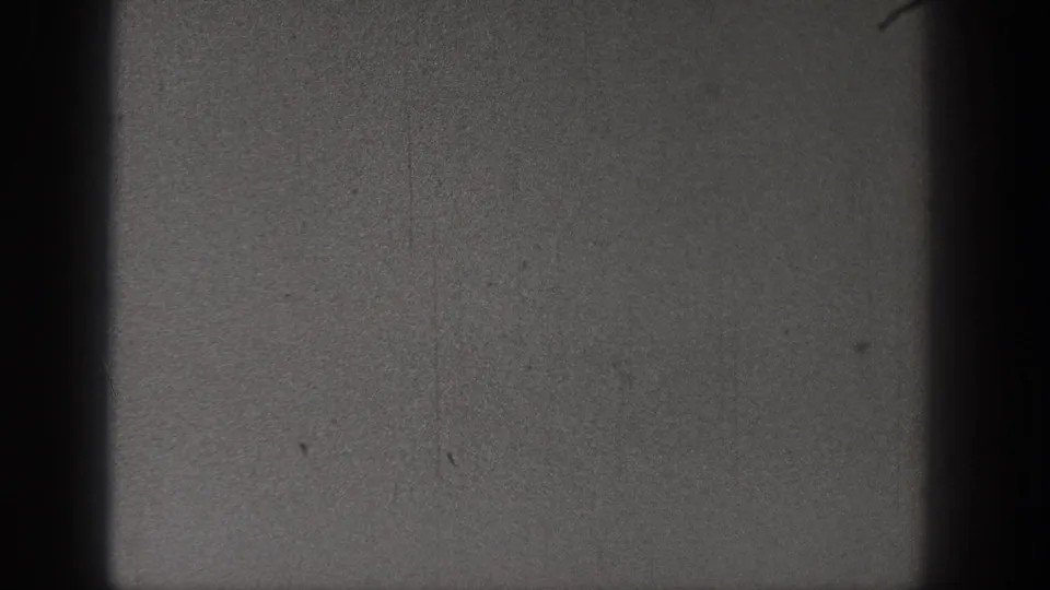 A dim 1938 Washington 8mm still with grain, faint scratches, and no clearly identifiable subject in the visible frame.