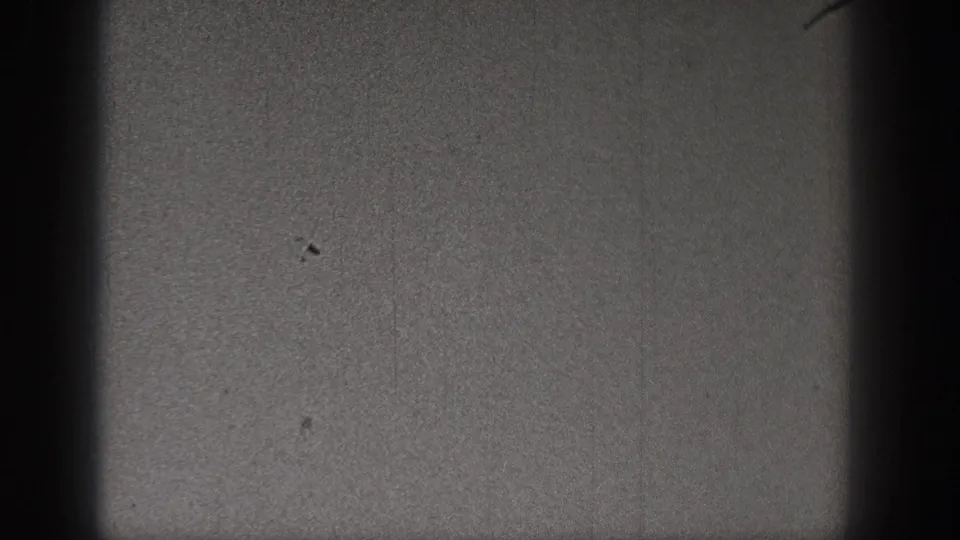 1938 Washington 8mm frame with a small bird-like speck low in the dark, grainy sky and visible film wear.