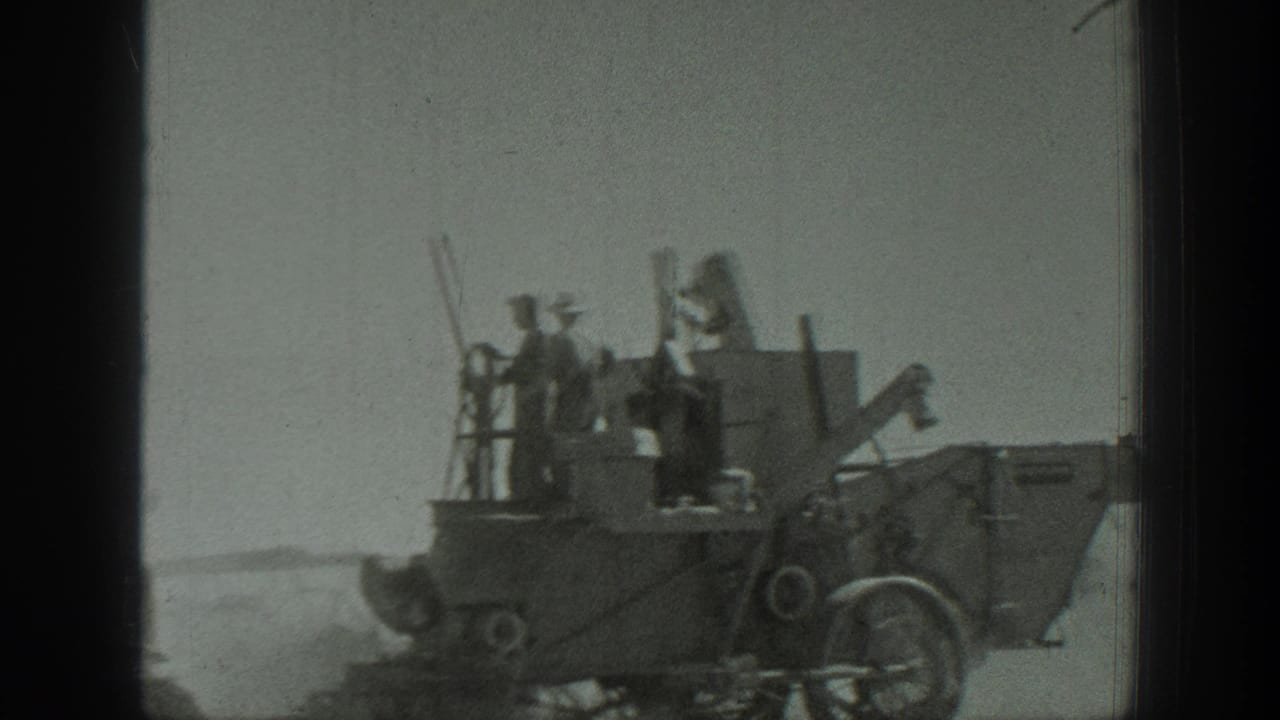 California 1939 home-movie frame showing several workers on a large grader-like construction machine in open ground.