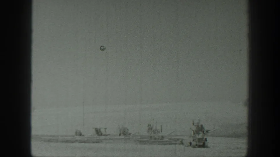 Soft 8mm frame from California in 1939 showing small boats on calm water, with possible tiny passengers visible at a distance.