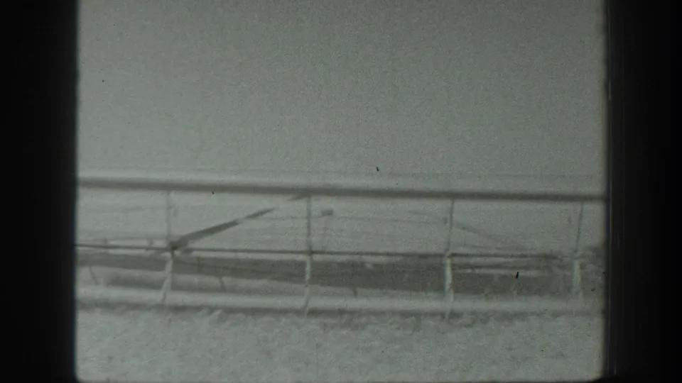 A long cutter or harvesting attachment extends across the frame in the California field scene.