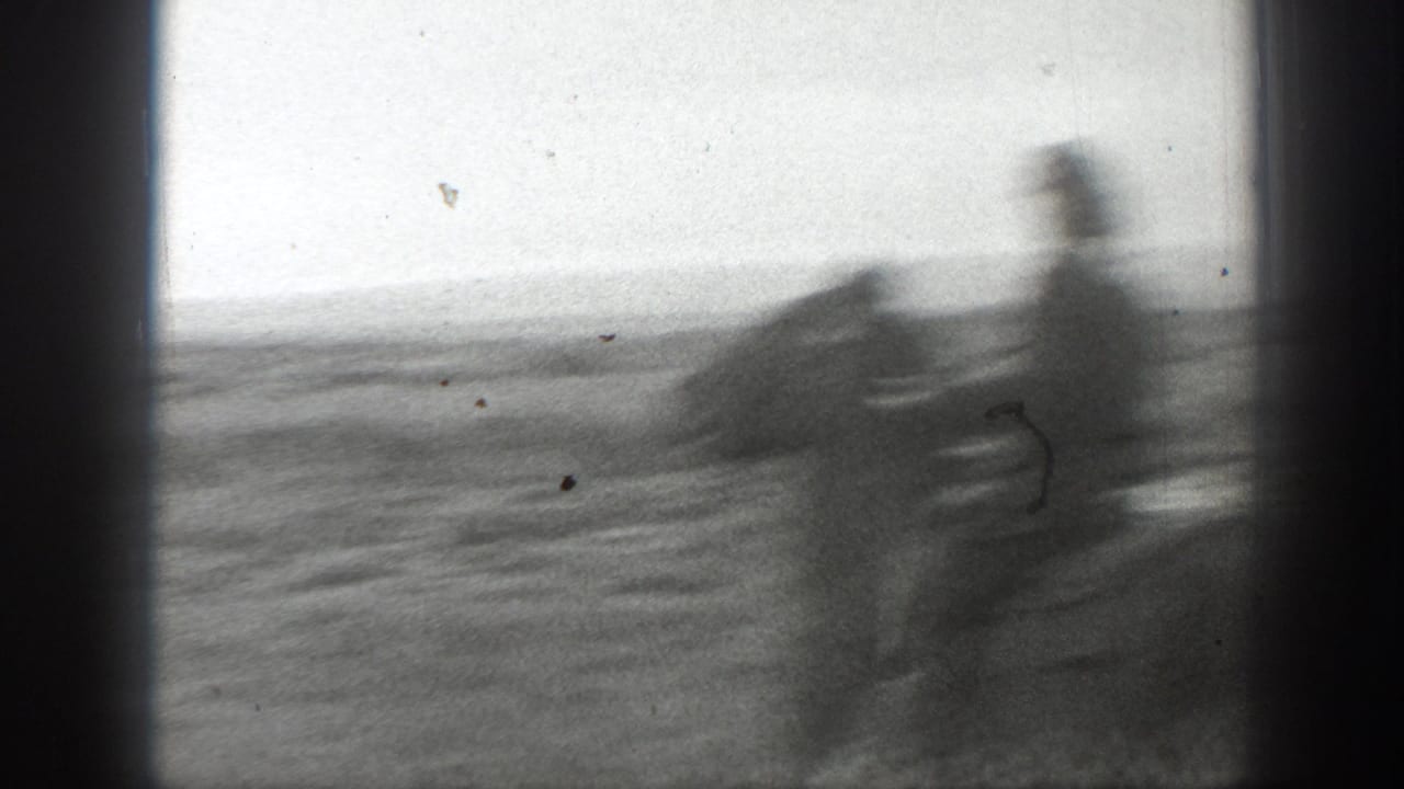 A motion-blurred rider and horse pass through an open Montana field in the 1939 home-movie clip.