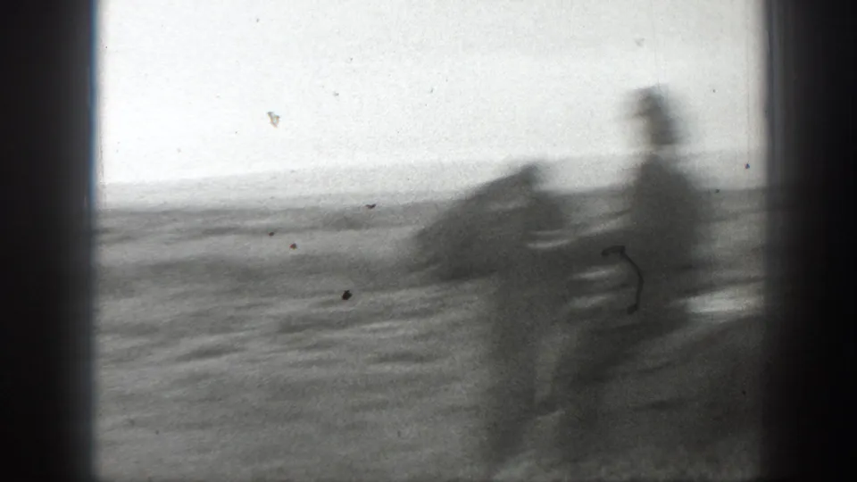 A motion-blurred rider and horse pass through an open Montana field in the 1939 home-movie clip.