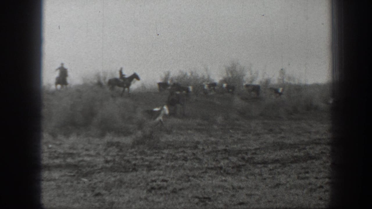 In the supplied 1939 Montana context, distant riders on horseback herd cattle across sparse open ground.