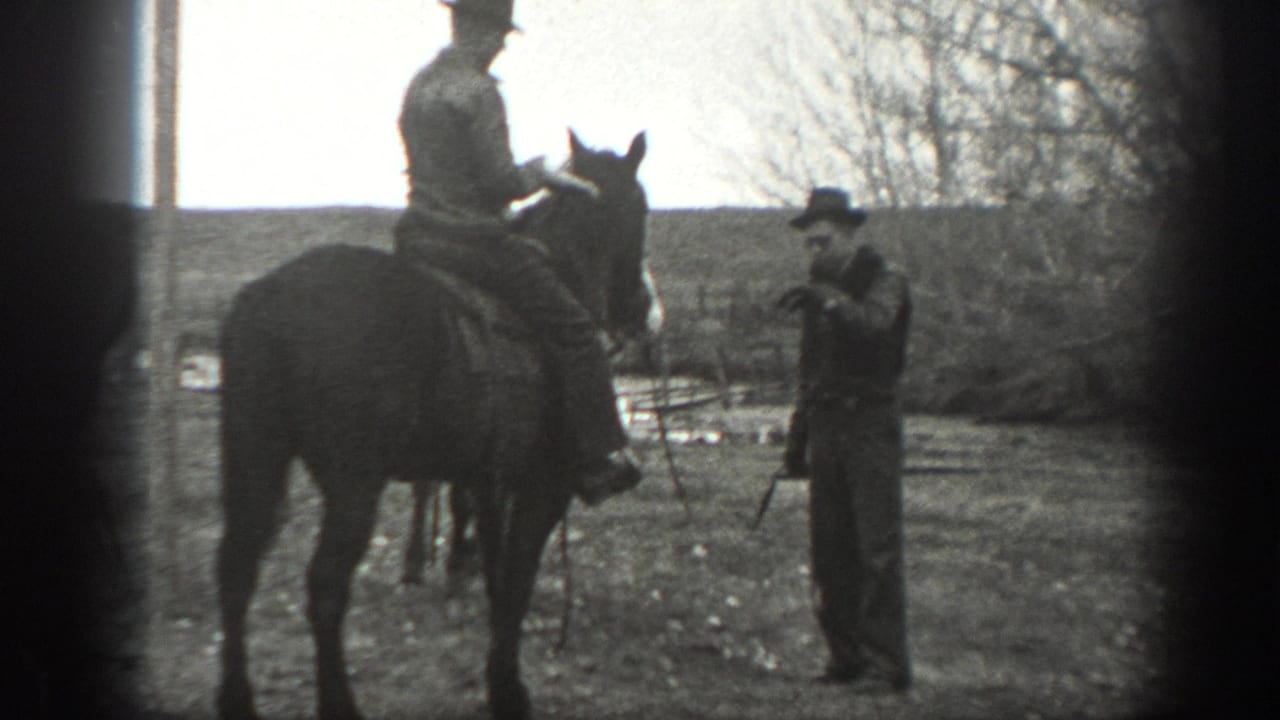 1939 Montana ranch footage shows a man on horseback near another man standing with a lead or reins in an open field.