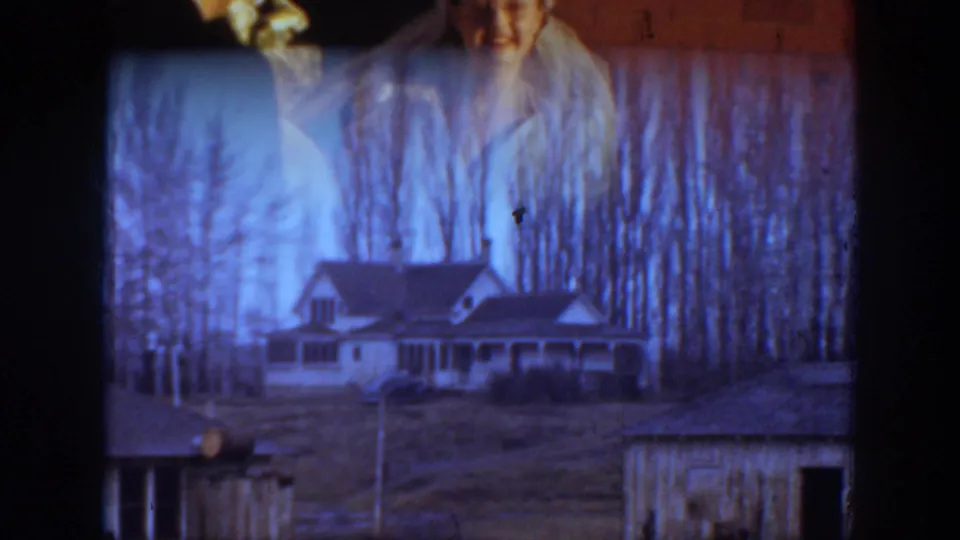 A rural Montana house and leafless trees appear in a double-exposed or transition-like frame with the bride faintly visible above.