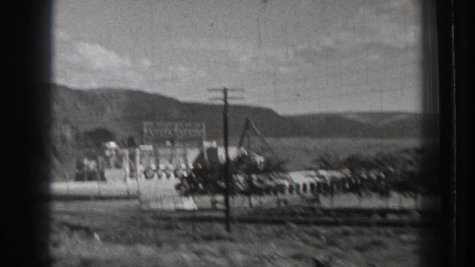 1939 Washington view of the Rock Island Dam area appears to show electrical framework, utility poles, industrial buildings, and dry hills.