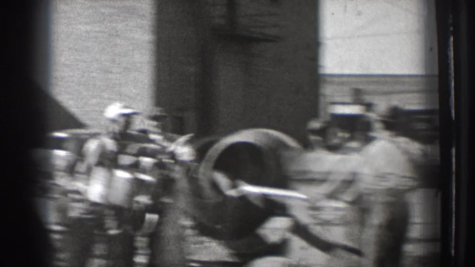 The handheld camera blurs slightly as workers and the cement mixer move through the frame at the Washington construction site.