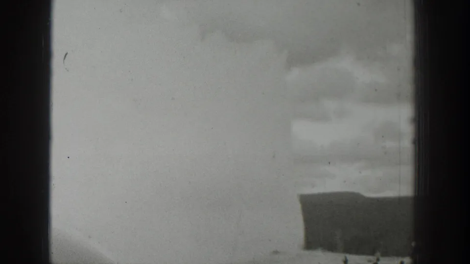 1939 Wyoming 8mm frame with a faint water or steam plume, dark foreground shape, and visible film wear.