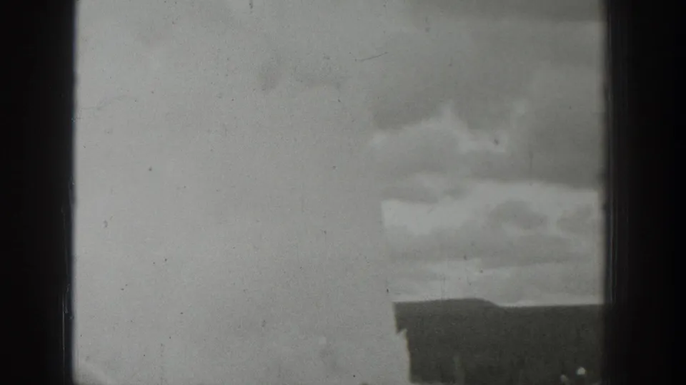 1939 Wyoming black-and-white 8mm view of a distant plume with tiny spectators gathered below a dark foreground edge.