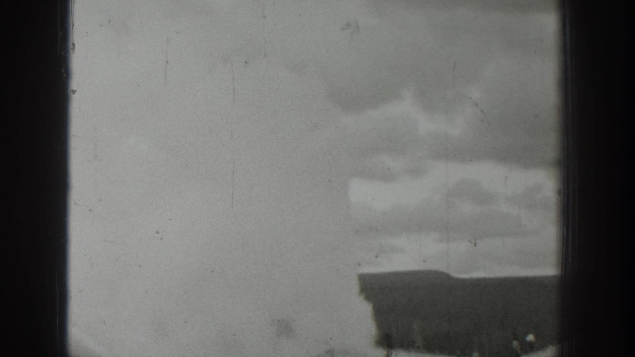 1939 Wyoming 8mm frame showing overcast sky, film gate edges, and the top of a town building entering the lower view.