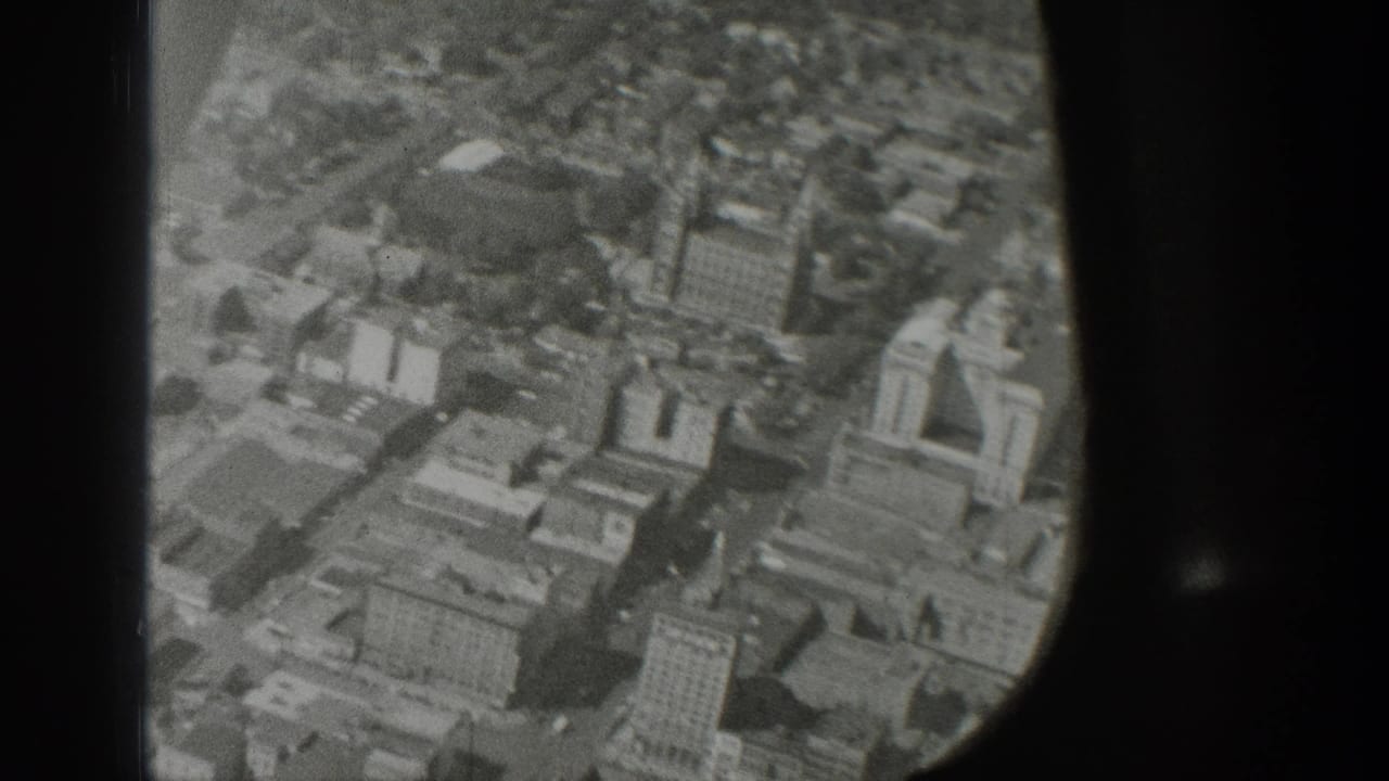 Oblique aerial view of buildings, streets, and surrounding urban blocks.