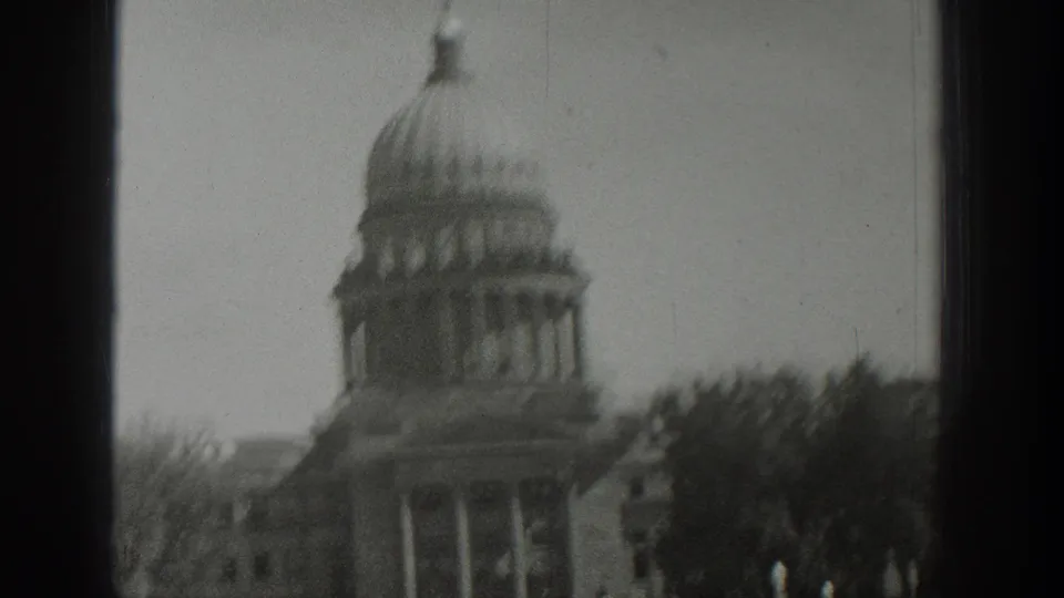 Black-and-white 8mm frame from Wyoming in 1939 showing the domed civic building blurred by handheld motion.