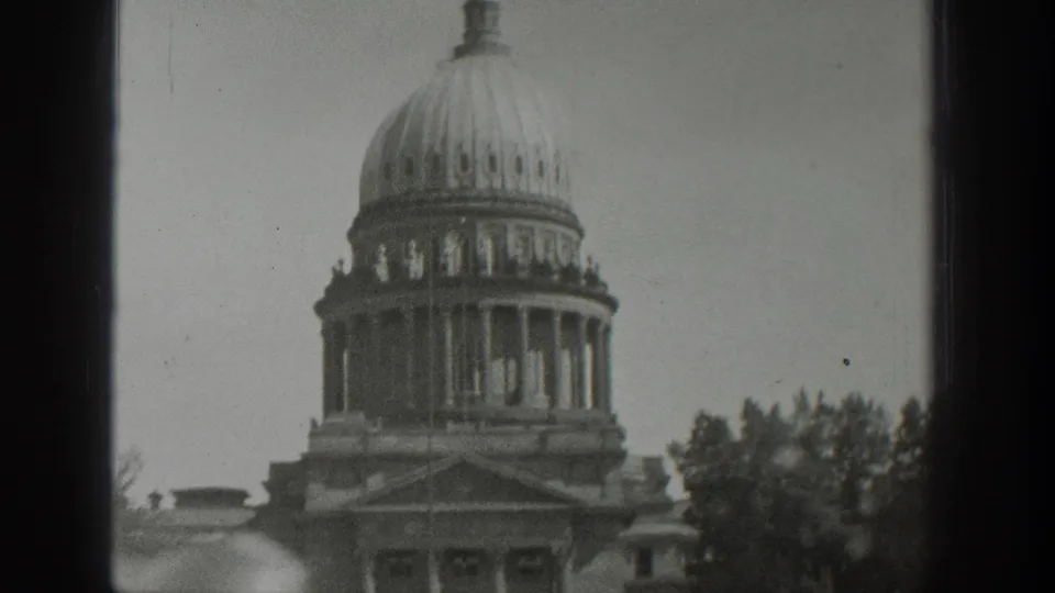 A domed civic-looking building in Wyoming, dated by metadata to 1939, appears through a window with trees at the side.