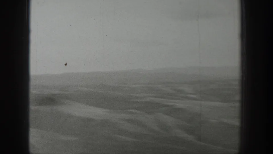 1939 Wyoming 8mm home-movie frame showing hazy open desert terrain, low hills, and dark film gate edges.