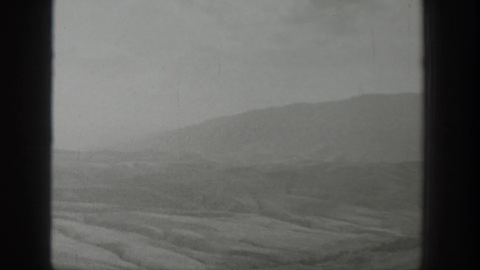 1939 Wyoming 8mm home-movie frame with an open desert plain, distant hills, haze, and visible black film borders.