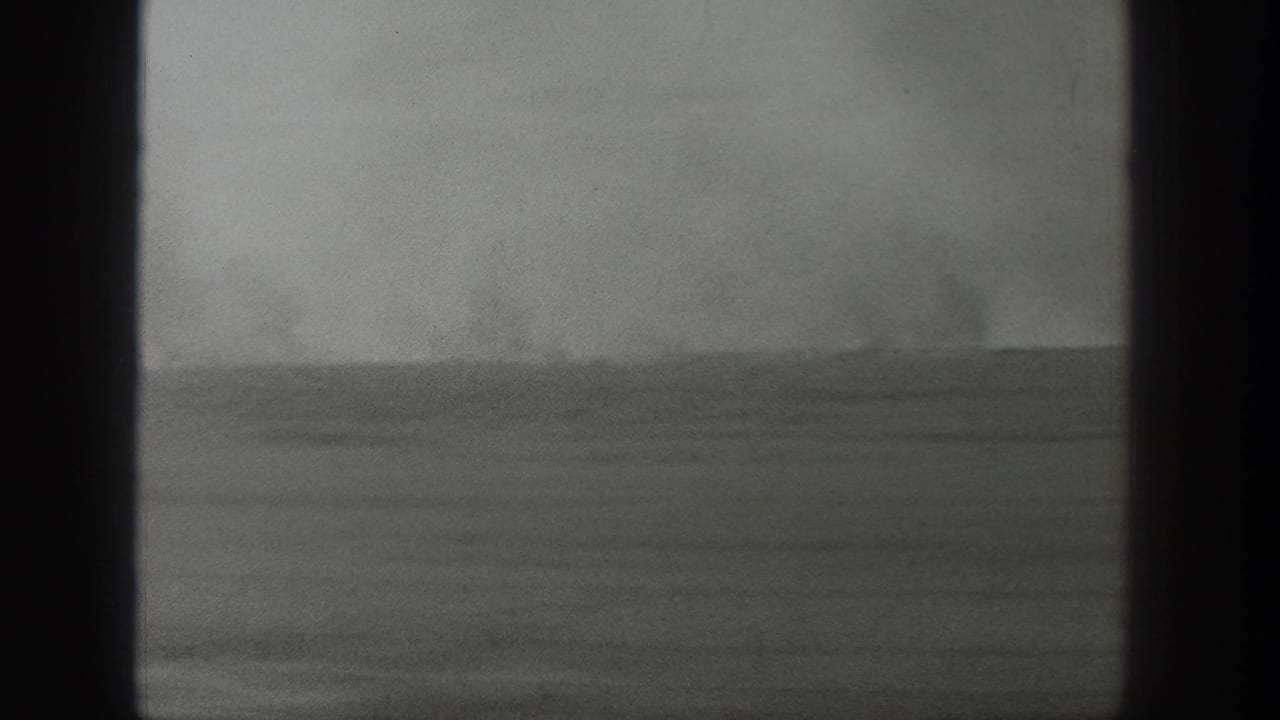 Wide flat horizon with faint smoke or steam visible in the distance.