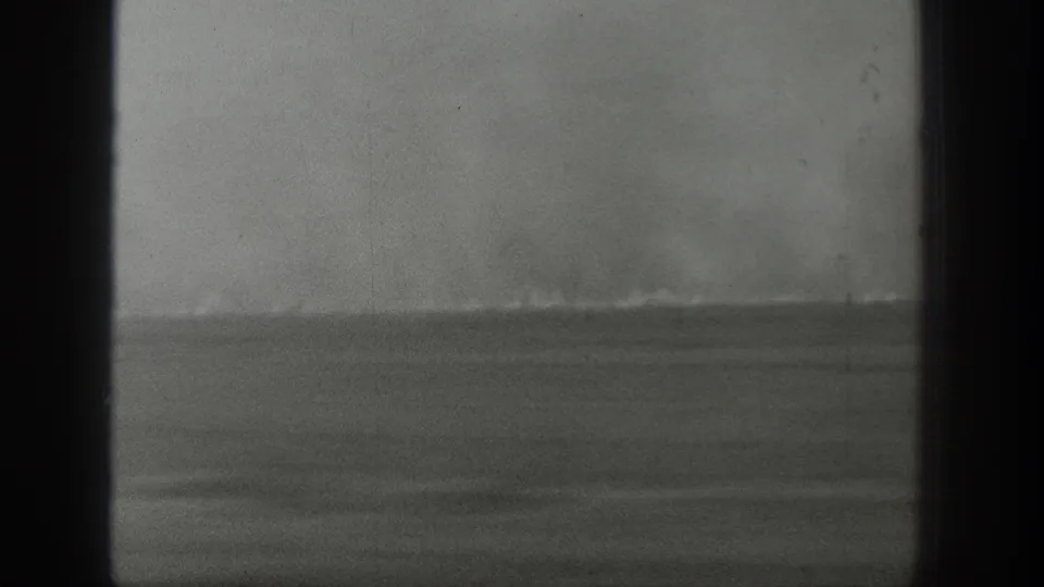 Late frame from the 1939 Wyoming clip showing a muted horizon and softened smoke or steam in grainy 8mm footage.