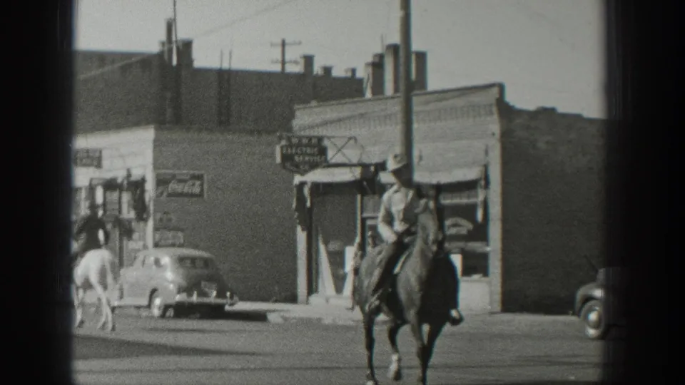 The final frame shows a cowboy-hatted rider on a dark horse facing forward, with storefronts, cars, and a white horse behind him.