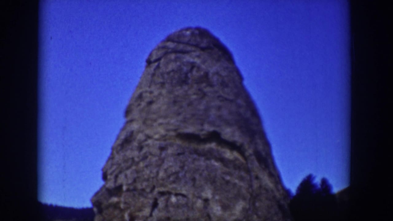 1939 Wyoming 8mm frame showing a tall weathered stone formation silhouetted against a deep blue sky.