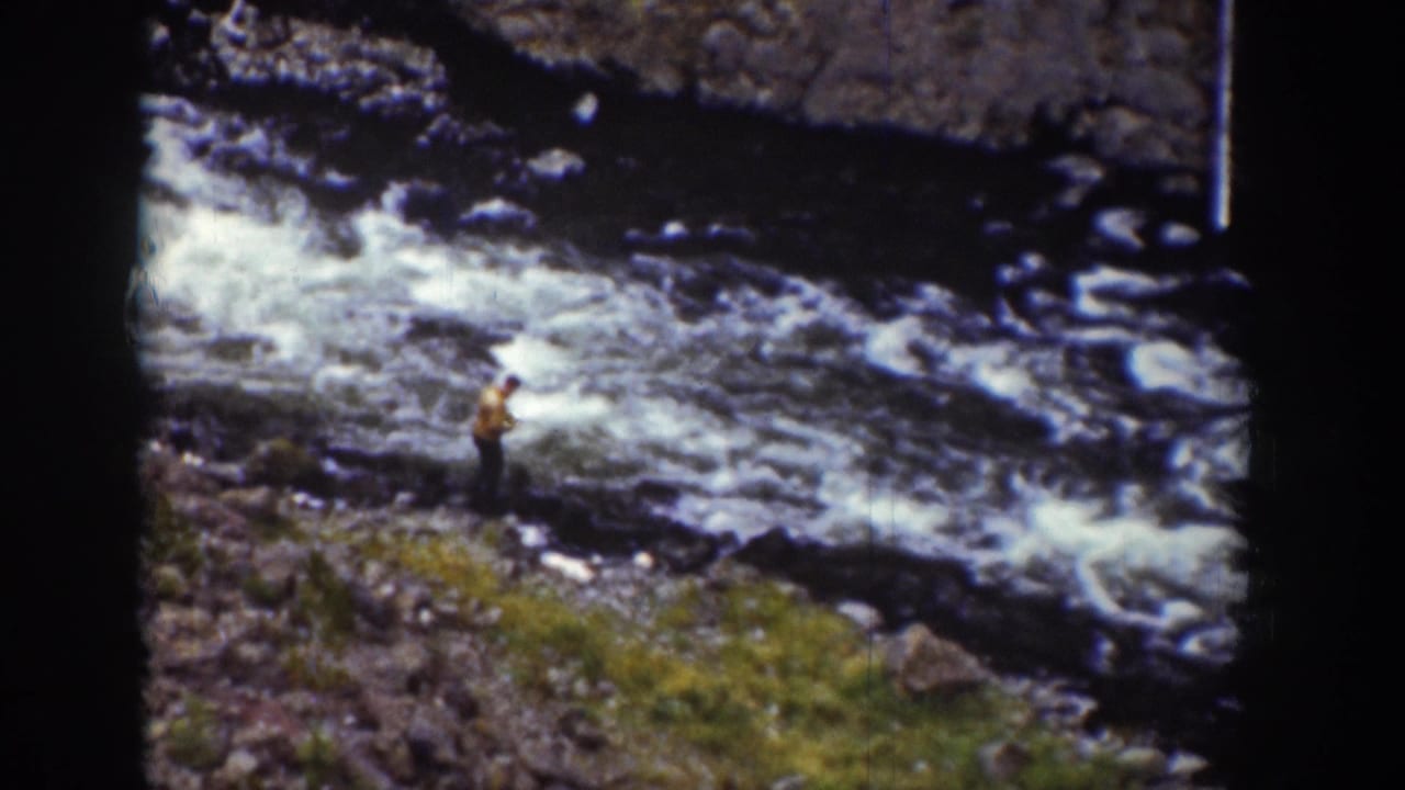 1939 Wyoming 8mm frame showing a man in a light shirt near fast water and a rocky mountain stream.