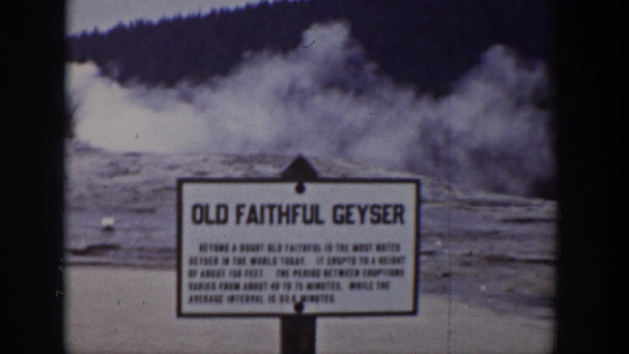 1939 Wyoming 8mm frame showing the Old Faithful Geyser sign with an eruption plume rising behind it.