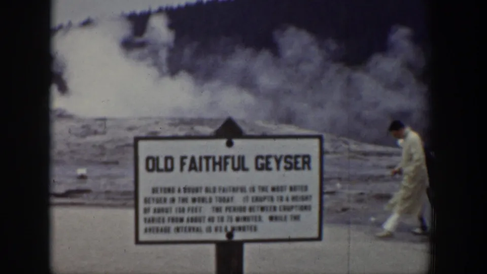 1939 Wyoming visitor footage of the Old Faithful sign as an adult walks past during the eruption.