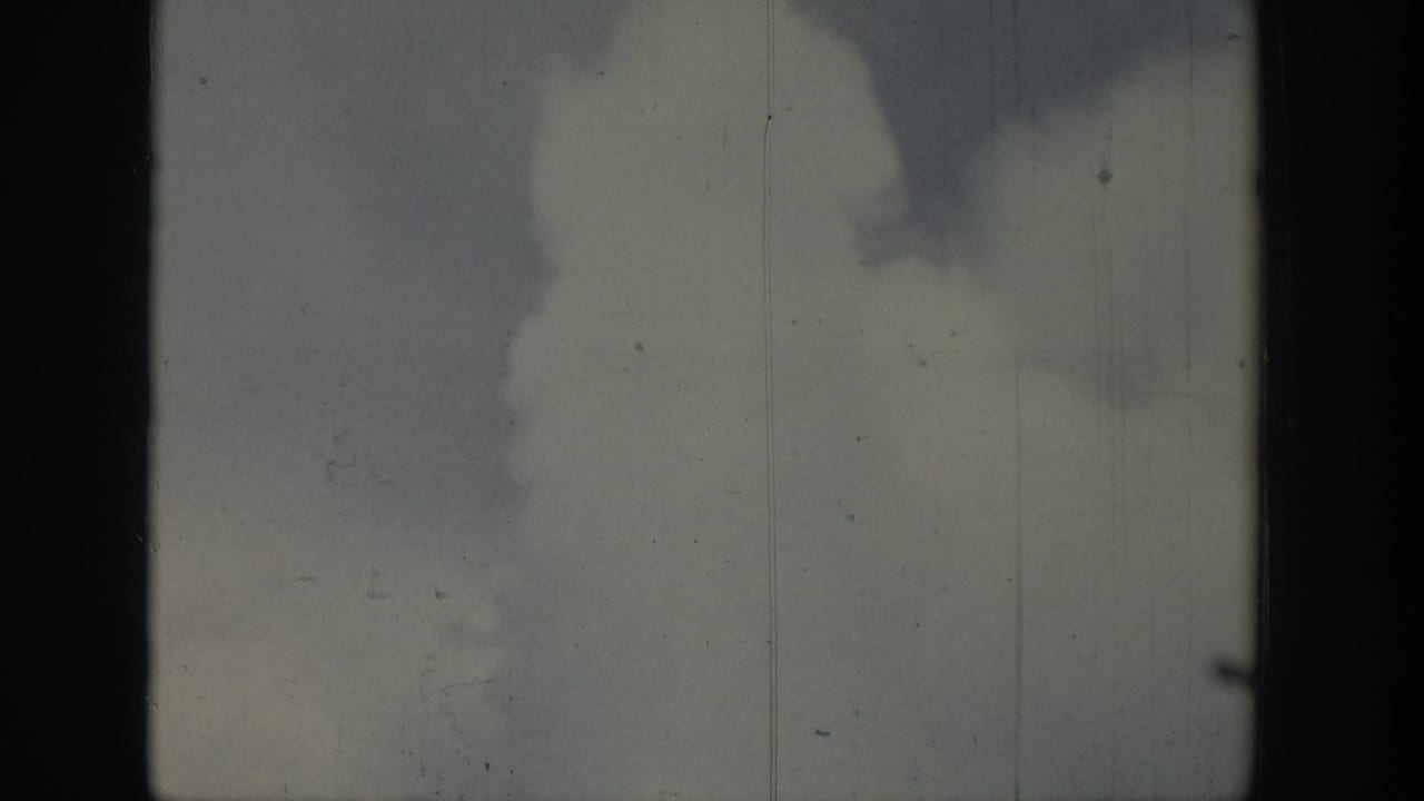 1939 Wyoming 8mm frame showing pale sky, dark smoke-like forms, and visible film wear.