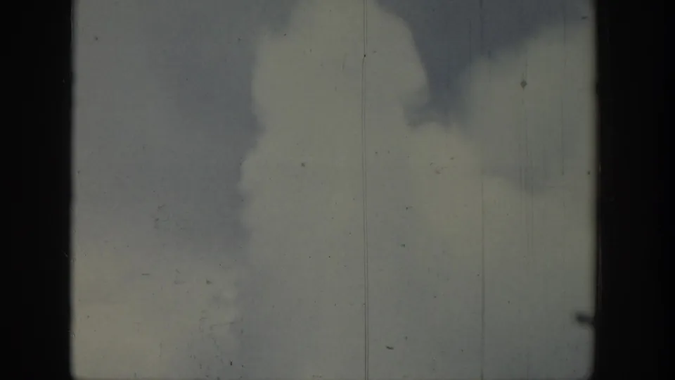 1939 Wyoming 8mm frame showing pale sky, dark smoke-like forms, and visible film wear.