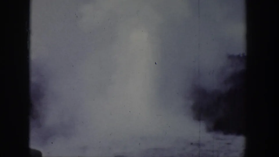 1939 Wyoming-attributed 8mm frame showing a brighter plume with darker smoky shapes along the lower edge.