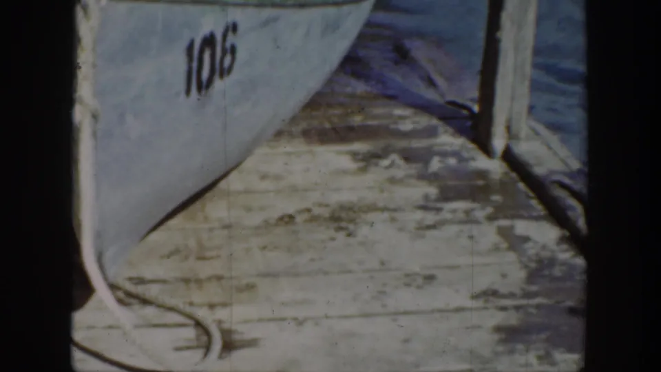1939 Wyoming 8mm frame of the numbered boat and dock area after the animal has moved out of view.