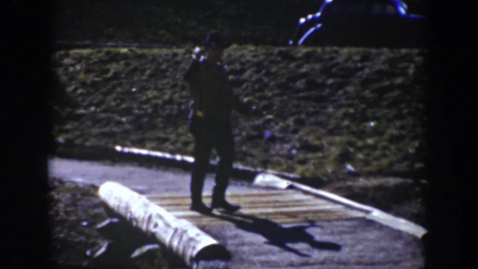 1939 Wyoming park footage shows a suited visitor gesturing from a boardwalk near hot spring steam.