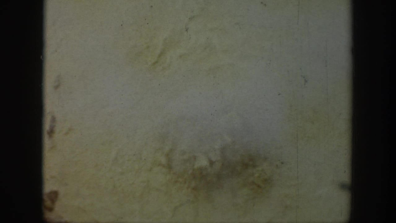 Faded 8mm frame from the 1939 Wyoming clip, mostly obscured by film wear and gate edges with no clear subject visible.