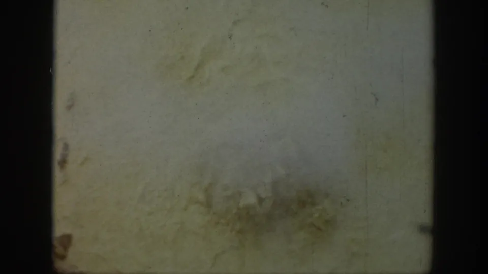 Faded 8mm frame from the 1939 Wyoming clip, mostly obscured by film wear and gate edges with no clear subject visible.