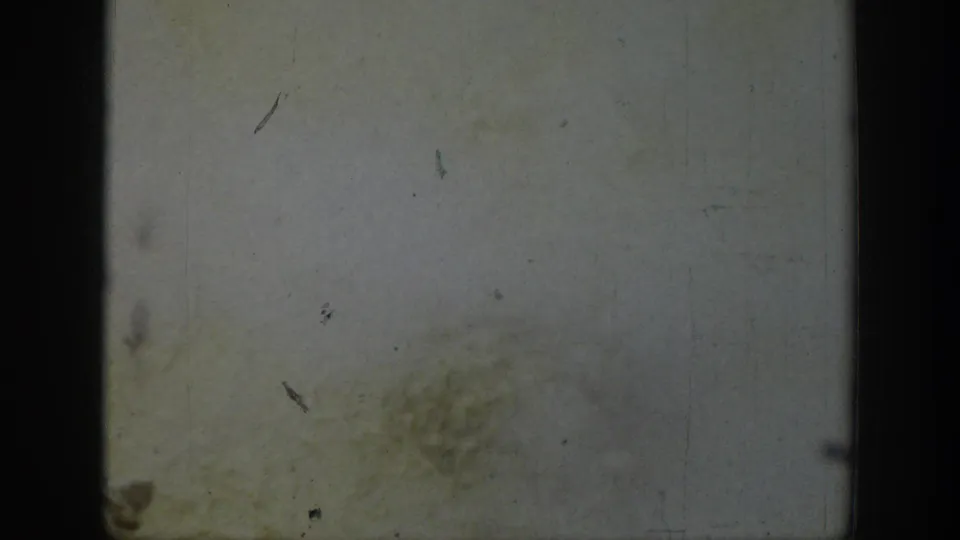 Worn 8mm frame from the 1939 Wyoming footage, largely obscured by fading, dust, scratches, and film gate borders.
