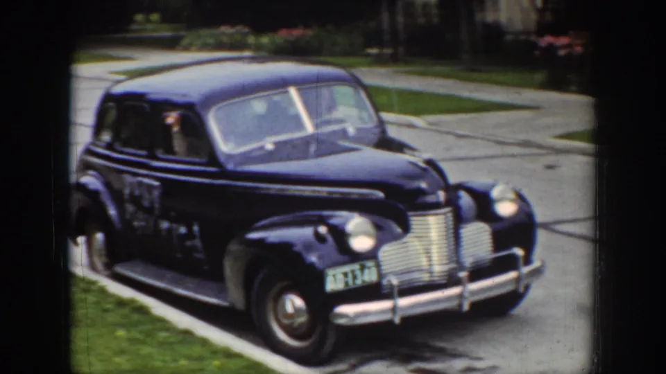 The 1939 Wyoming home movie shows the sedan from the front as a passenger remains visible at the side window.