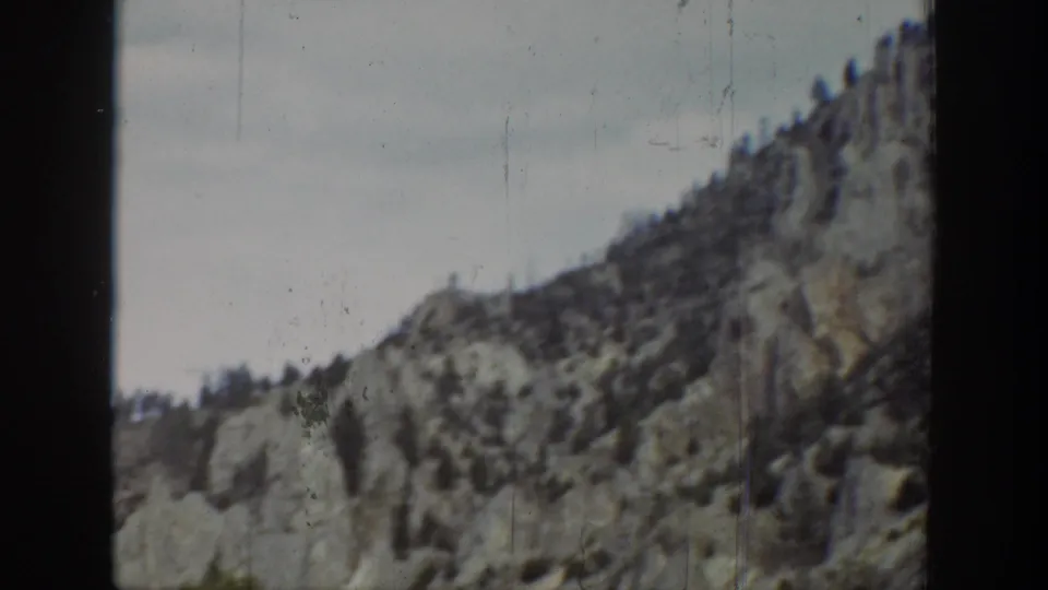 1939 Wyoming 8mm view of a rocky ridgeline with scattered conifers and aged film border visible.