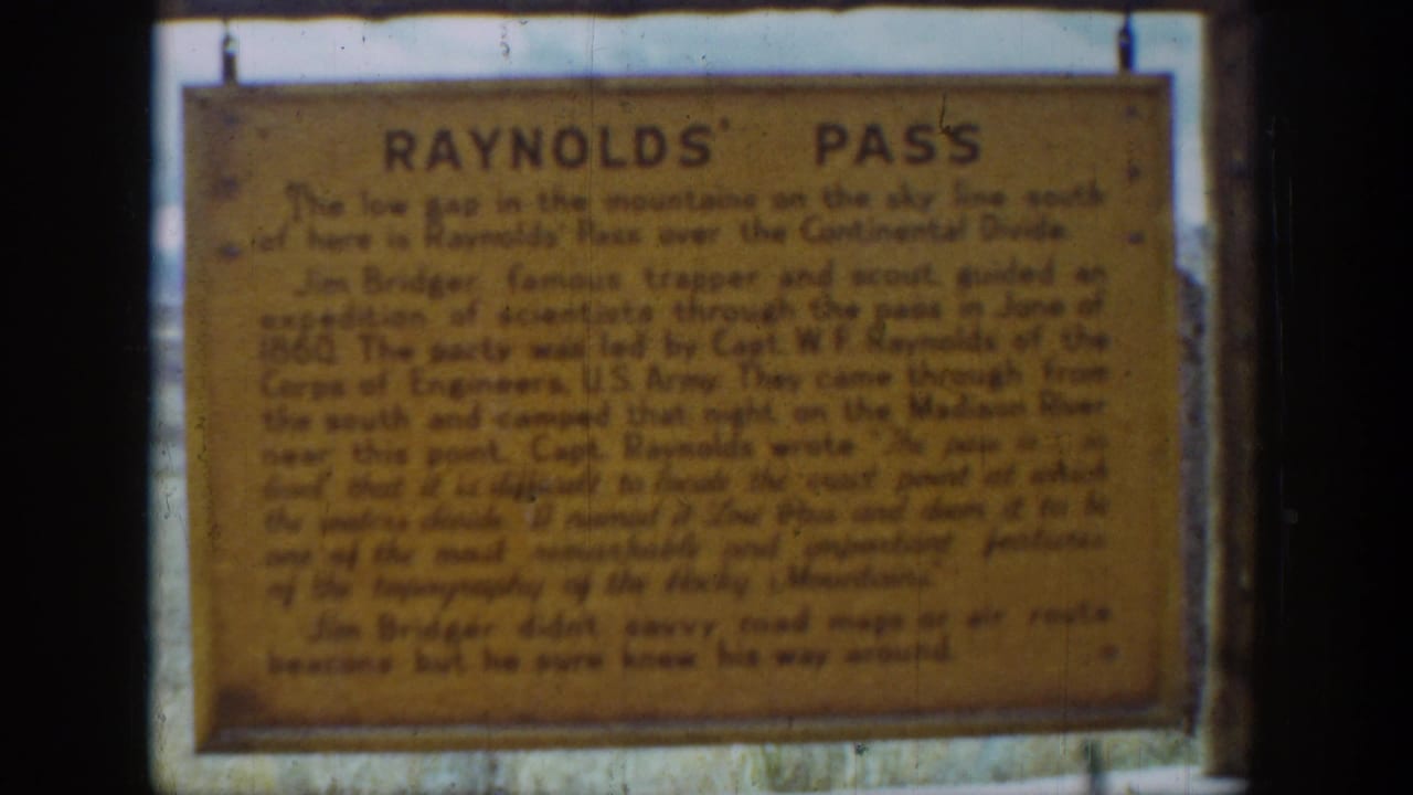 Weathered Reynolds' Pass sign in Wyoming, recorded as a close visitor-shot 8mm view in 1939.