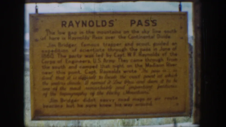 Weathered Reynolds' Pass sign in Wyoming, recorded as a close visitor-shot 8mm view in 1939.