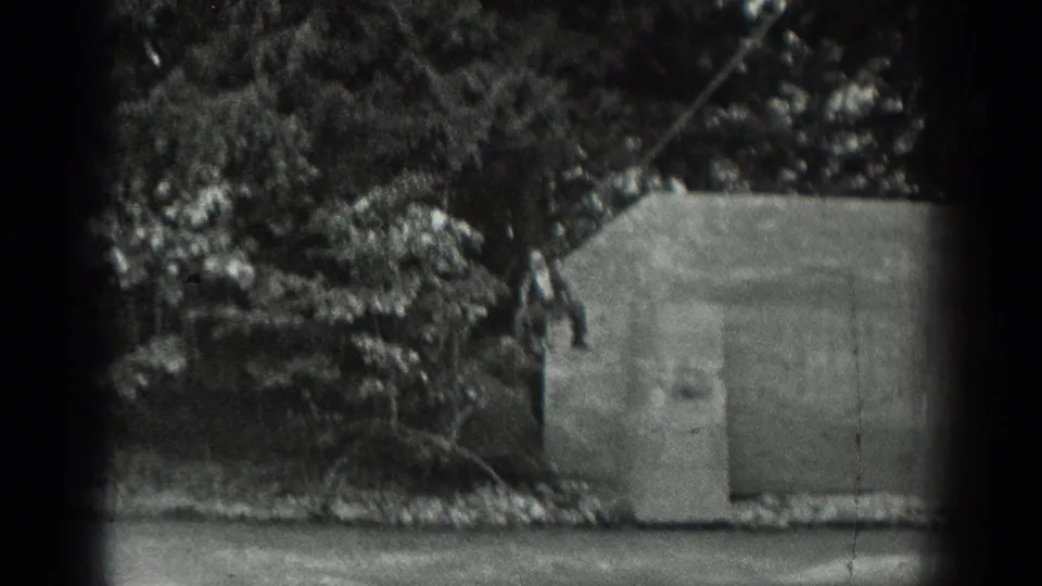 Final 1940 Washington frame shows the wooded setting, concrete structure, and part of the cable ride area as the action moves out of view.