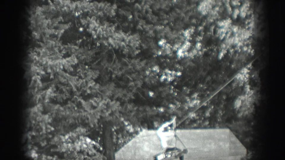 Near the end of the short 1940 Washington clip, the man stays braced on the line crossing setup against a dense tree background.