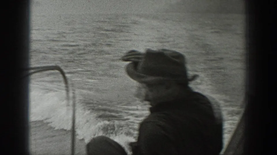 A motion-blurred 1940 Washington frame shows the fedora-wearing passenger turning in profile as the boat moves across the river.