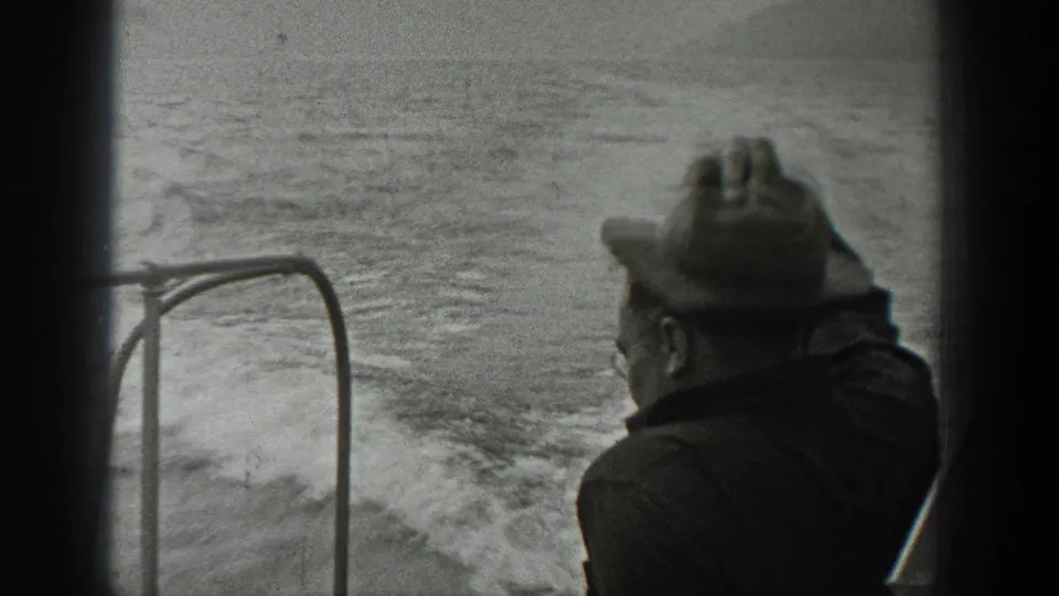 A fedora-wearing man sits near the boat rail in the 1940 Washington footage, with wake and textured water visible behind him.