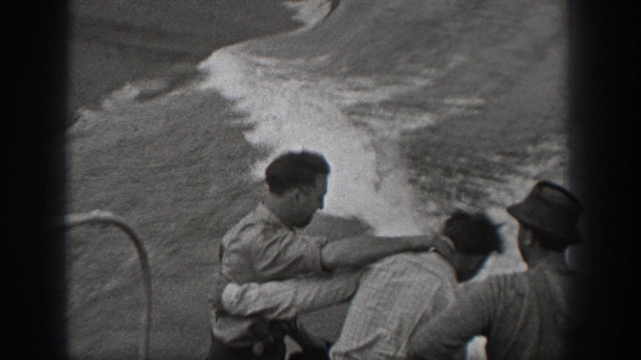 A man reaches toward another passenger while waves break beside the ship.
